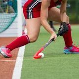 Field hockey player ready to pass ball team mate 124374771